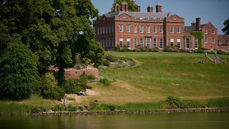 View across Big Pool towards the mansion and rockery (left) at Dudmaston Hall, Shropshire